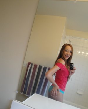 18 year old girl Katie Lewis stands naked after undressing in her bedroom